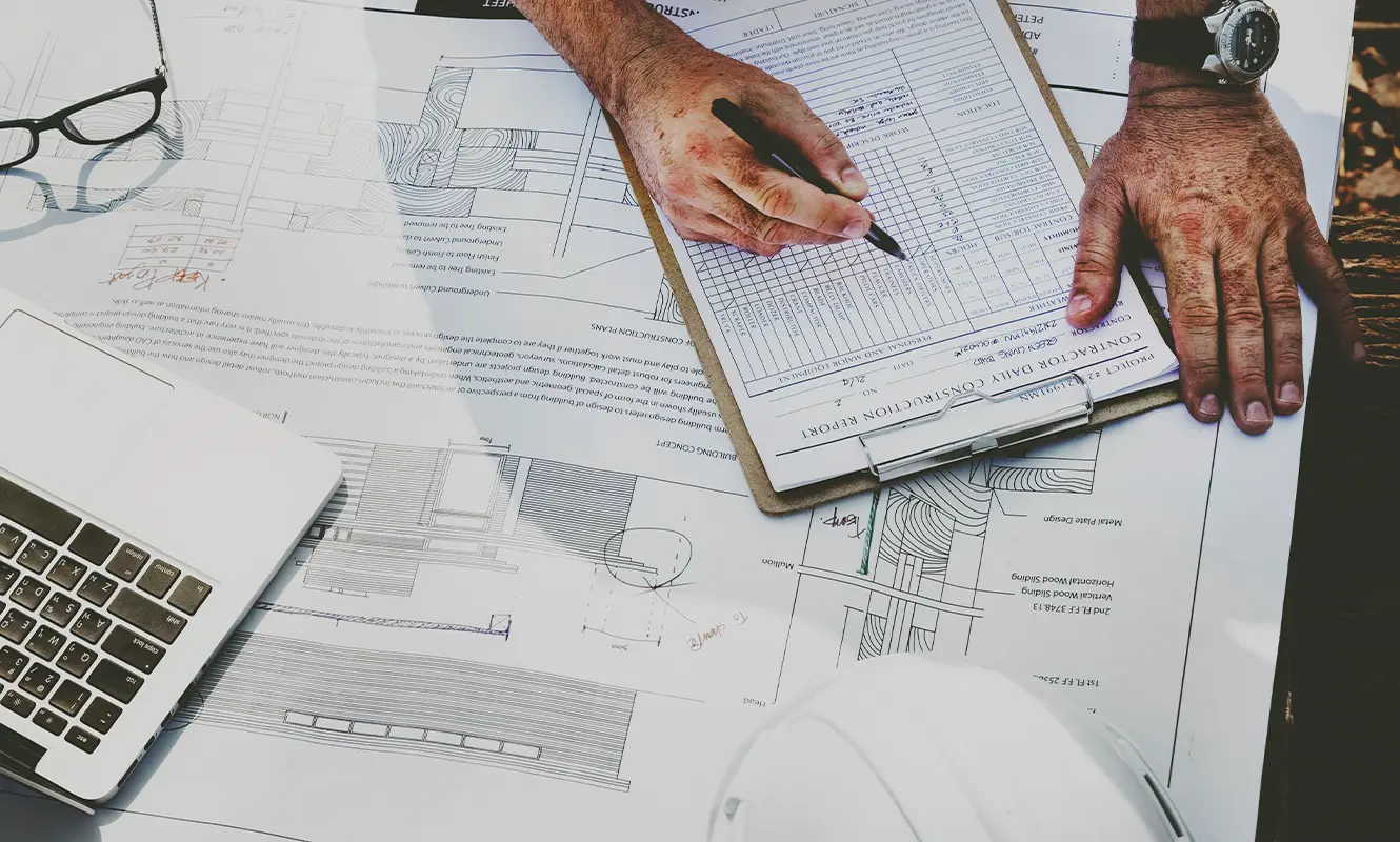 Engineering-Sydney-dilapidations-reports at a desk, working on a number of dilapidation reports