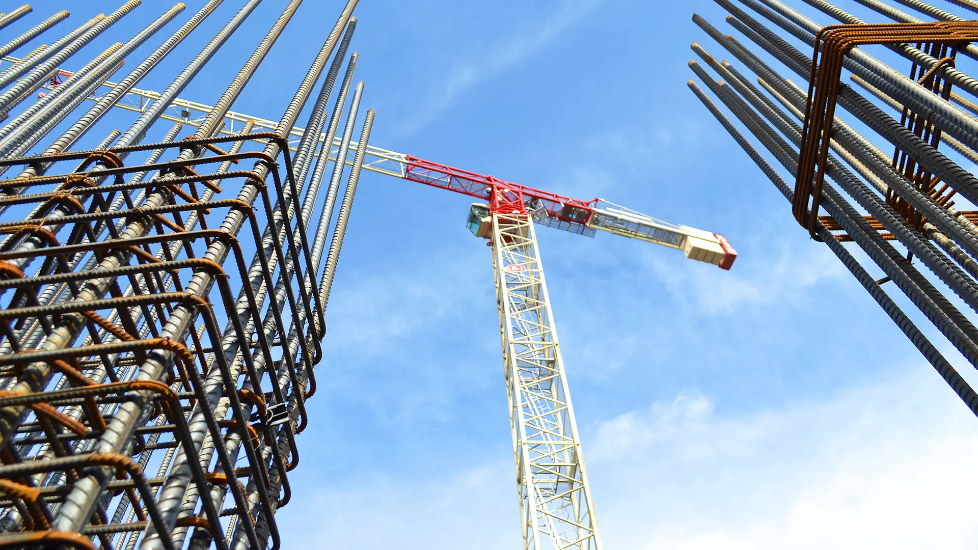 Large crane towering above commercial construction site