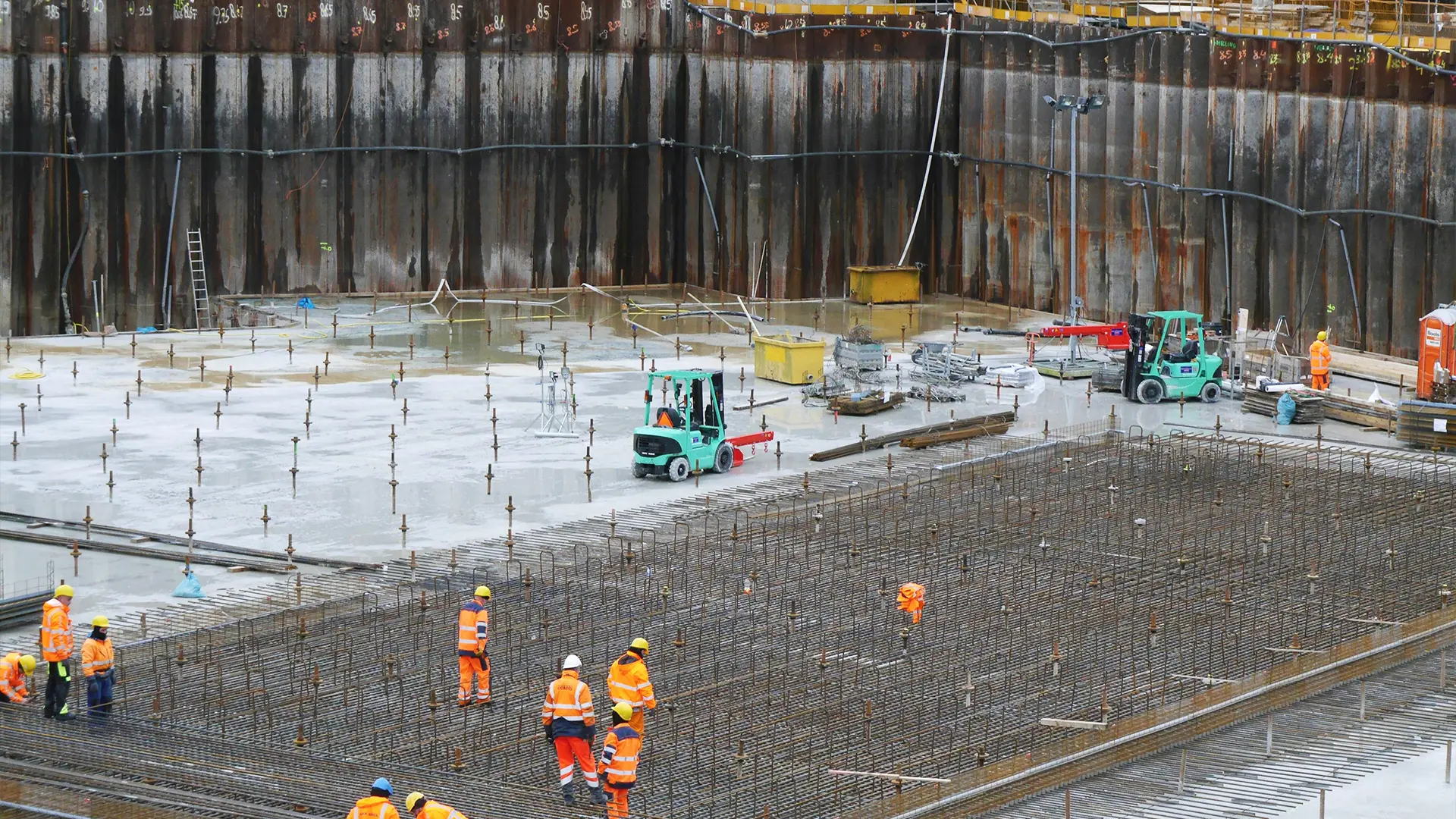 Large commercial job site with numerous workers looking around